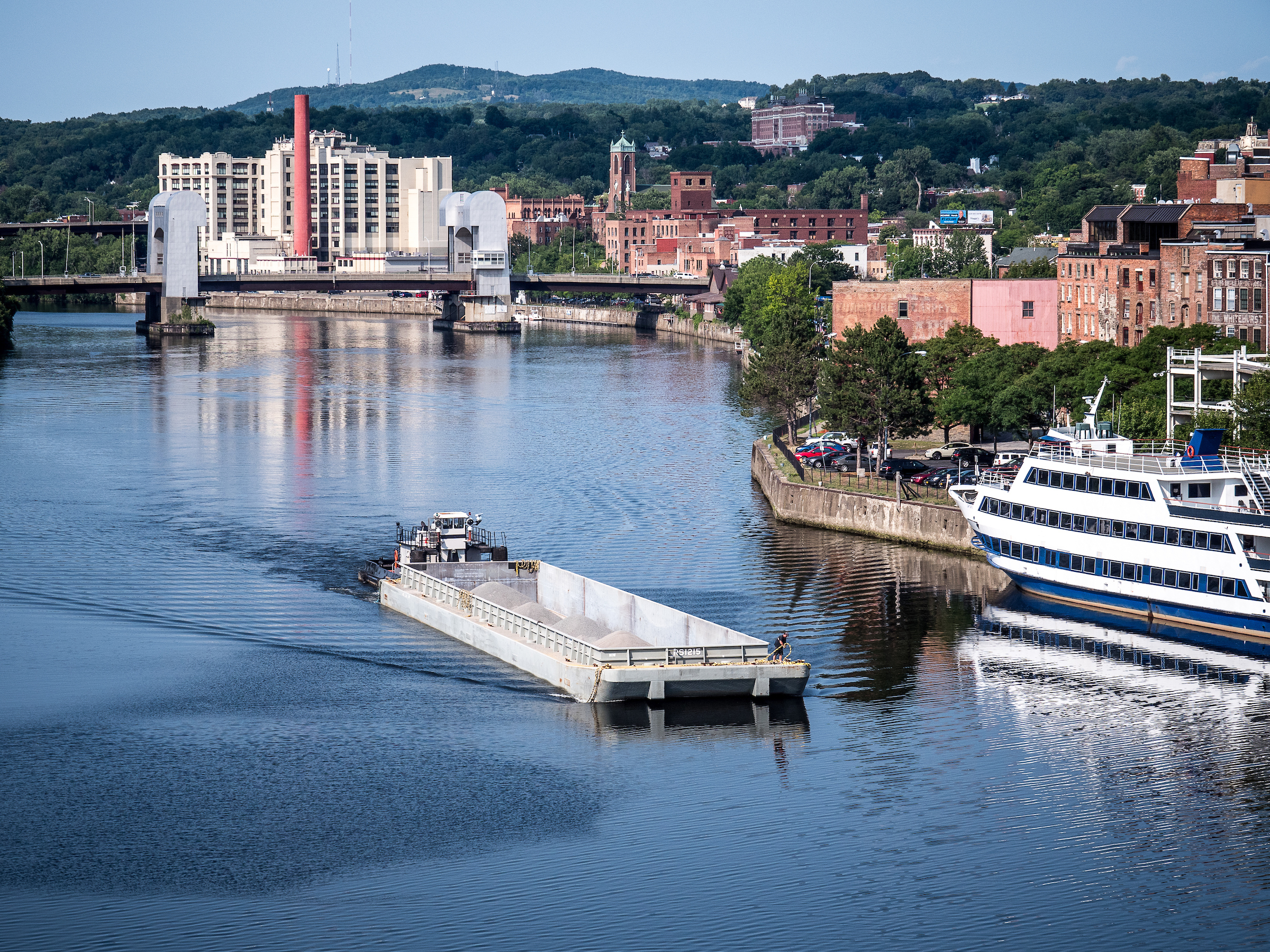 Tug with large cargo barge in canal